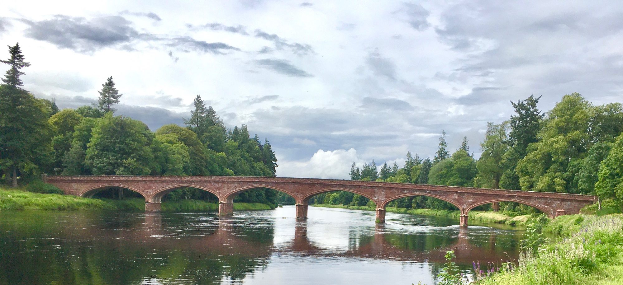 Kinclaven Bridge, a red sandstone multi-arch bridge over the River Tay in Perthshire, Scotland